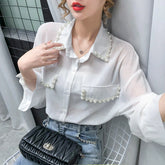 Blusa de gasa con cuentas y mangas largas